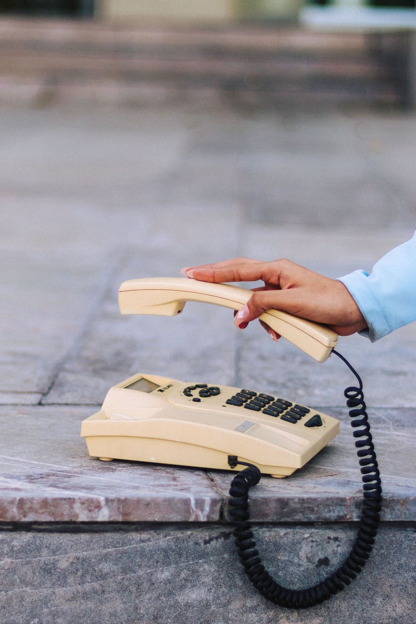 Close-up of a hand picking up a phone